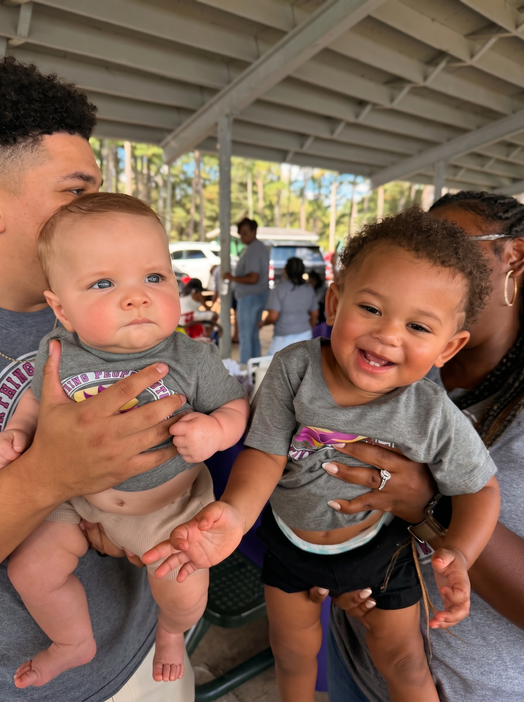 Two babies of the New Birth Ministries family smiling at a church cookout